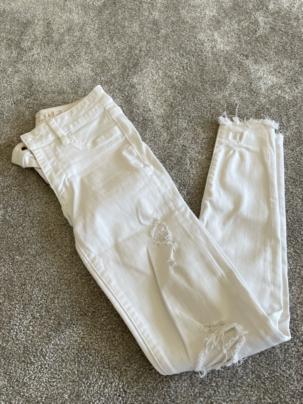 White American Eagle Ripped Skinny Jeans with Frayed Hem